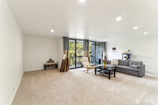 living area with a wall of windows, recessed lighting, baseboards, and light carpet