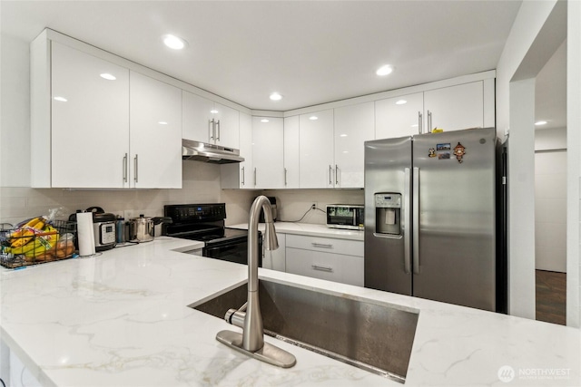 kitchen with light stone counters, black electric range, white cabinets, stainless steel refrigerator with ice dispenser, and under cabinet range hood