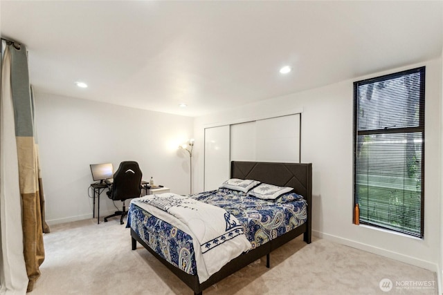 bedroom featuring recessed lighting, light colored carpet, baseboards, and a closet