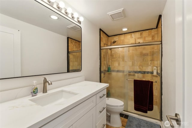 full bathroom featuring vanity, visible vents, recessed lighting, a shower stall, and toilet