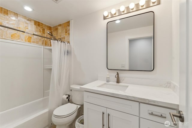 bathroom featuring toilet, shower / bath combo, and vanity