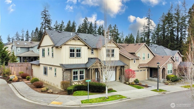 view of front of property featuring board and batten siding, fence, a residential view, stone siding, and driveway