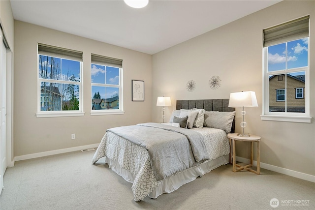 bedroom with carpet, visible vents, and baseboards