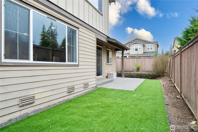 view of yard with a fenced backyard, visible vents, and a patio