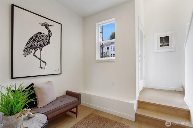 sitting room with baseboards and wood finished floors