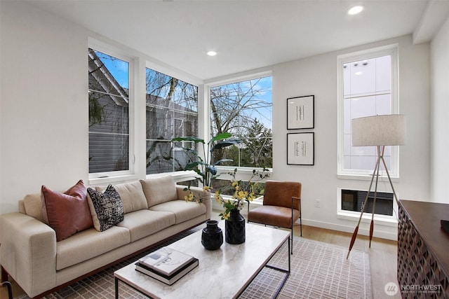 living room with baseboards, wood finished floors, and recessed lighting