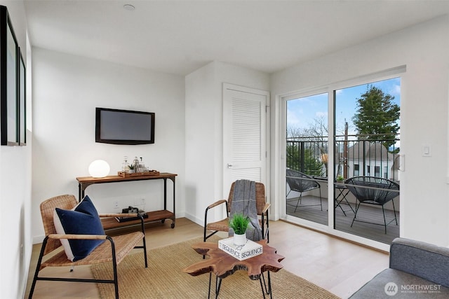 sitting room with wood finished floors and baseboards