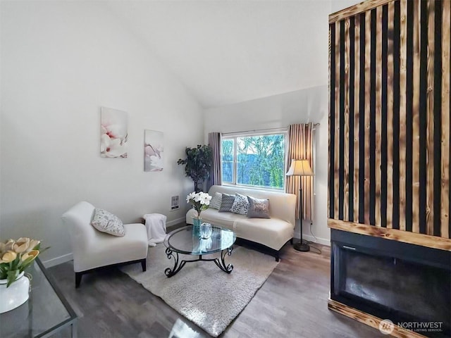 living area with baseboards and wood finished floors