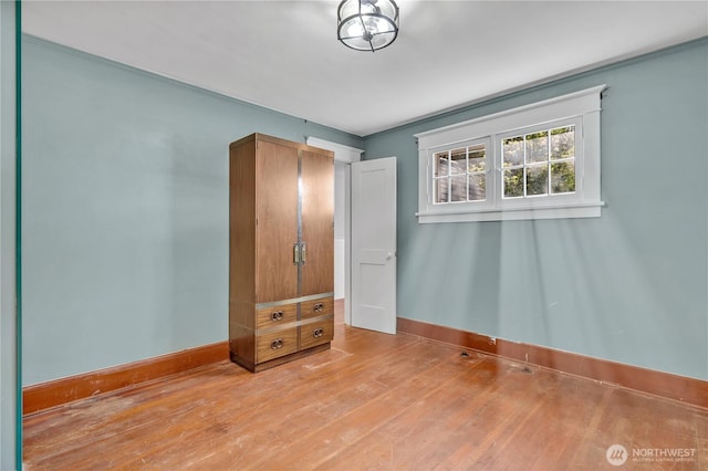 1501 13th St SE, Puyallup, WA 98372 - unfurnished bedroom featuring baseboards, wood finished floors, and ornamental molding