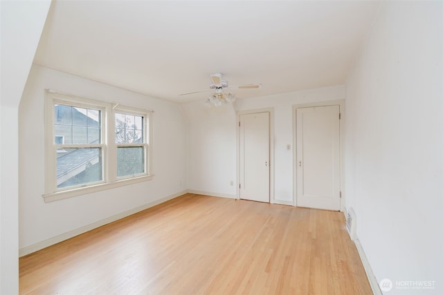 unfurnished bedroom featuring ceiling fan, visible vents, light wood-style flooring, and baseboards