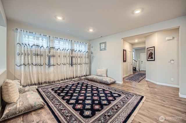 interior space with stairway, recessed lighting, wood finished floors, and baseboards