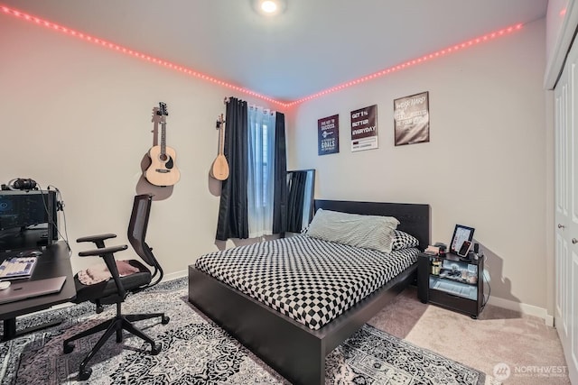 bedroom featuring baseboards and carpet flooring