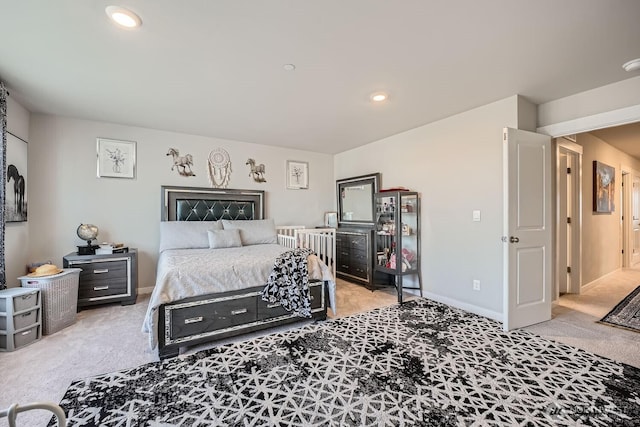 bedroom with baseboards, recessed lighting, and light colored carpet