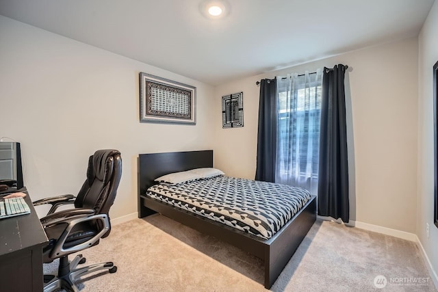 bedroom with baseboards and carpet flooring