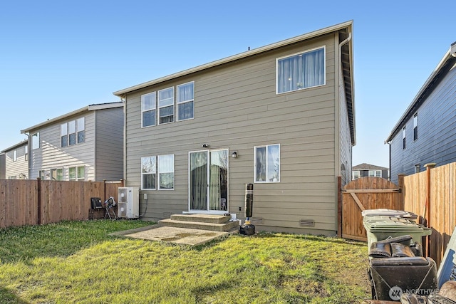 rear view of property with entry steps, fence, a yard, crawl space, and a gate