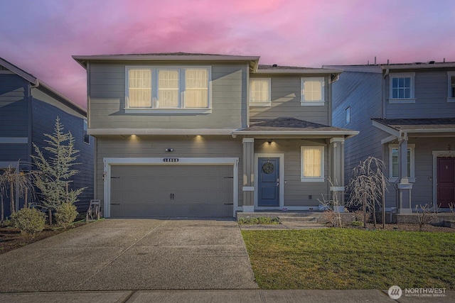 view of front of property featuring concrete driveway and an attached garage