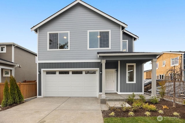 view of front of property featuring fence, an attached garage, covered porch, concrete driveway, and board and batten siding