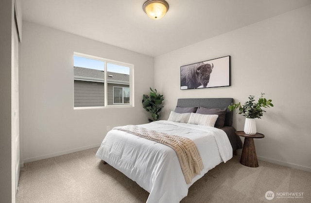 carpeted bedroom featuring baseboards