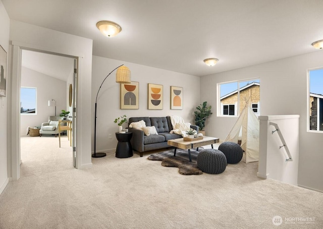 carpeted living area featuring lofted ceiling