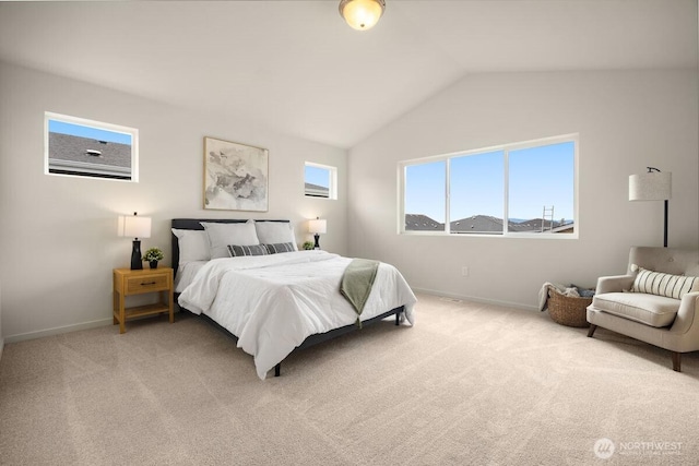 bedroom featuring baseboards, lofted ceiling, and light colored carpet