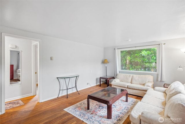 living room with wood finished floors and baseboards