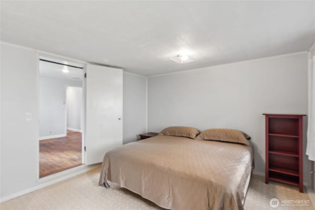 bedroom with baseboards and crown molding