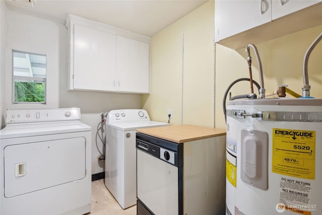 washroom with electric water heater, cabinet space, and washer and dryer