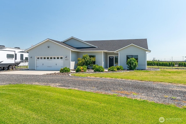 ranch-style house featuring a garage, driveway, and a front yard