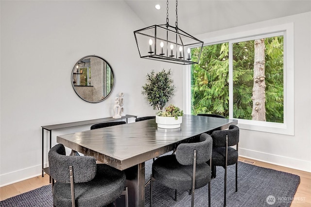 dining area with visible vents, baseboards, and wood finished floors