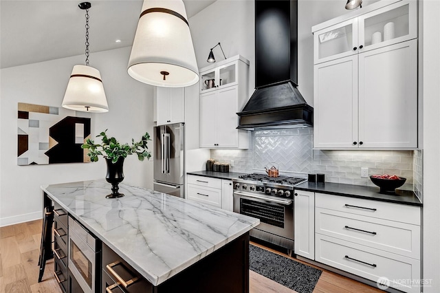 kitchen with a center island, light wood-style floors, white cabinetry, high quality appliances, and premium range hood