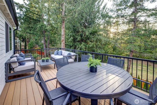 wooden terrace with an outdoor hangout area and outdoor dining space