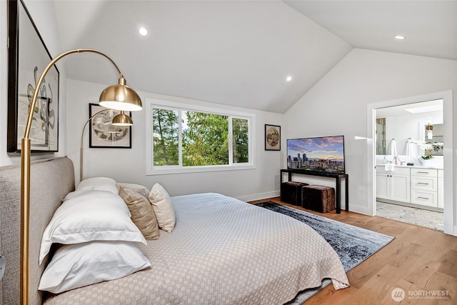 bedroom featuring baseboards, lofted ceiling, wood finished floors, ensuite bathroom, and recessed lighting