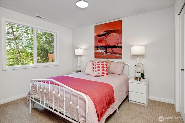 carpeted bedroom featuring baseboards and visible vents