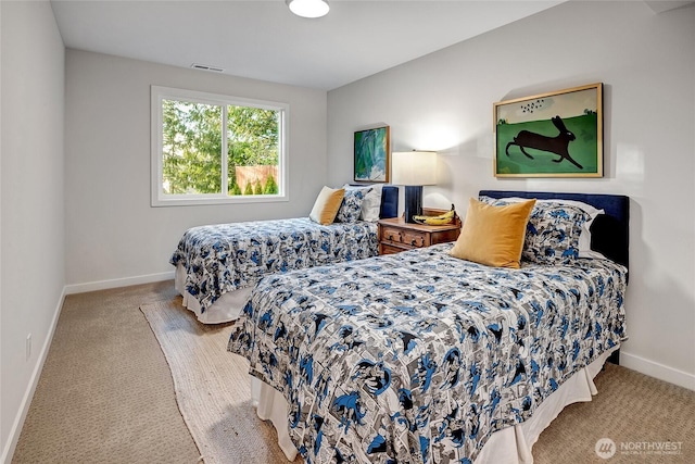 carpeted bedroom featuring visible vents and baseboards