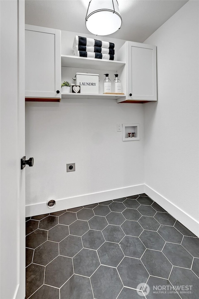 washroom featuring hookup for a washing machine, cabinet space, electric dryer hookup, and baseboards