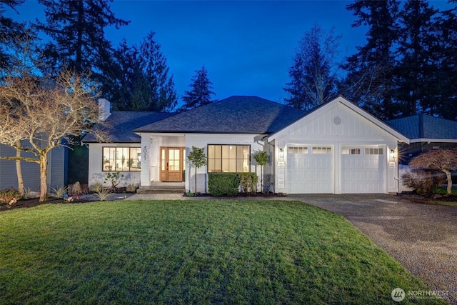 view of front of property featuring driveway, an attached garage, and a front yard