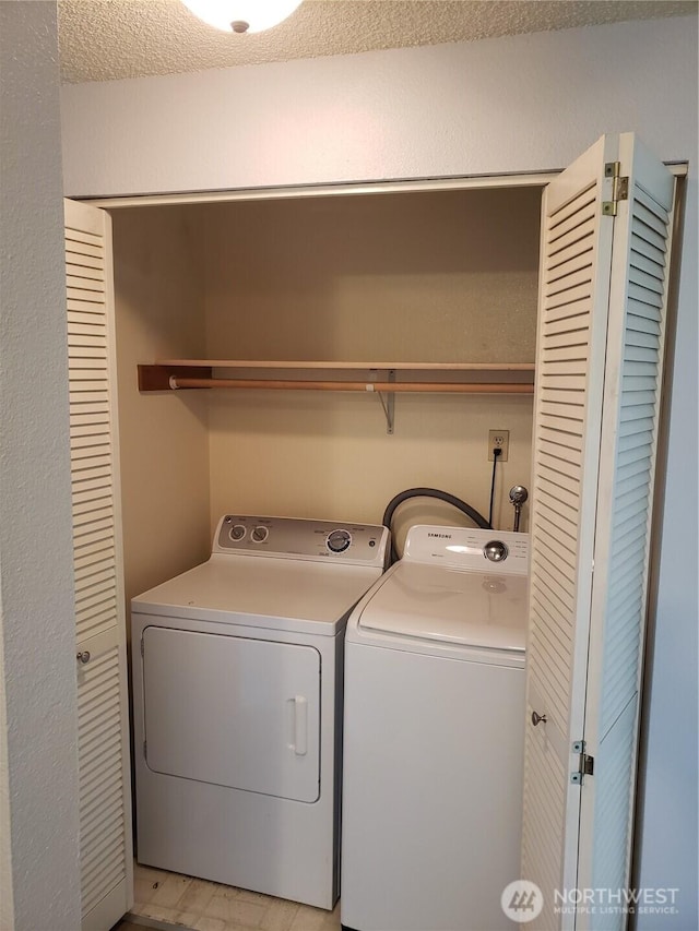 clothes washing area with laundry area and washing machine and clothes dryer