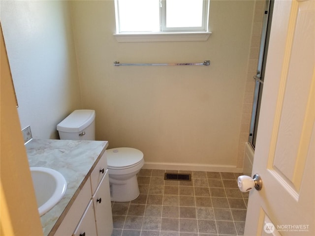 full bathroom featuring toilet, vanity, visible vents, and baseboards