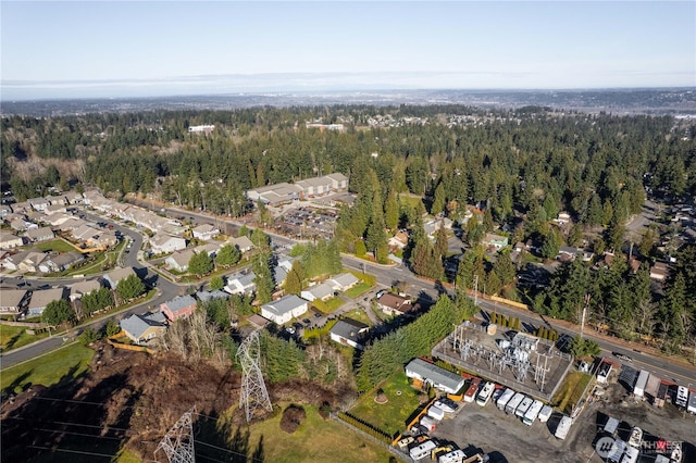 drone / aerial view featuring a wooded view