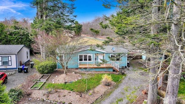 view of front of house featuring stairway and driveway