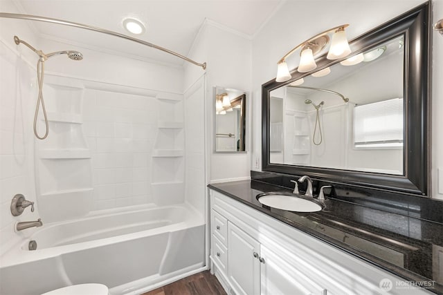 bathroom with tub / shower combination, vanity, crown molding, and wood finished floors