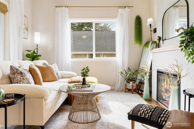 sitting room featuring a fireplace with flush hearth