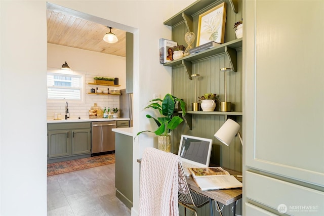 interior space with open shelves, a sink, decorative backsplash, light countertops, and stainless steel dishwasher