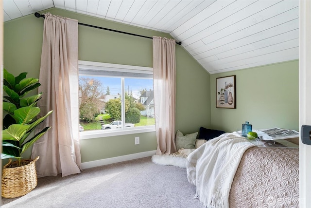 bedroom featuring vaulted ceiling, wooden ceiling, baseboards, and carpet floors