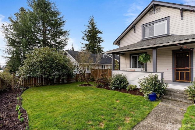 exterior space featuring a porch, roof with shingles, a yard, and fence