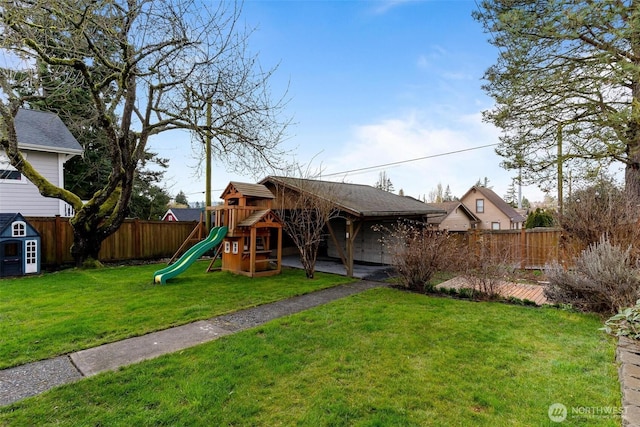 view of jungle gym with a patio, a fenced backyard, and a lawn