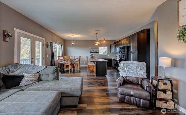 living area featuring baseboards, dark wood-style flooring, and french doors