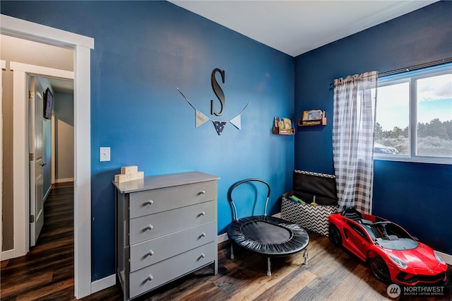 bedroom featuring baseboards and wood finished floors