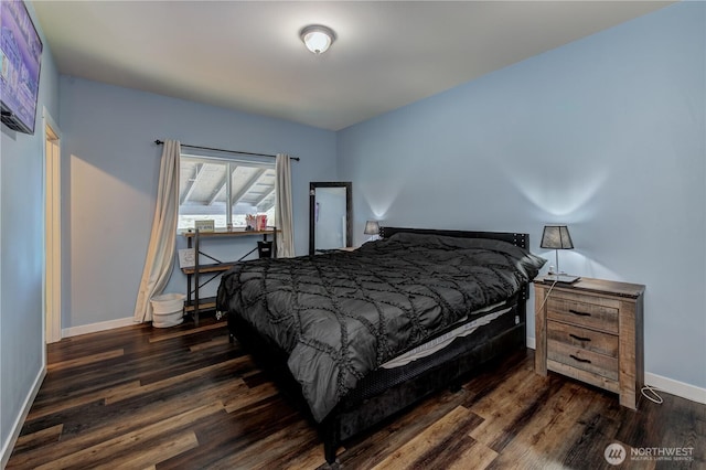 bedroom with dark wood-style floors and baseboards