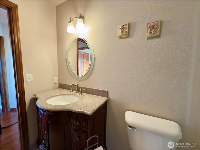 bathroom featuring toilet and vanity